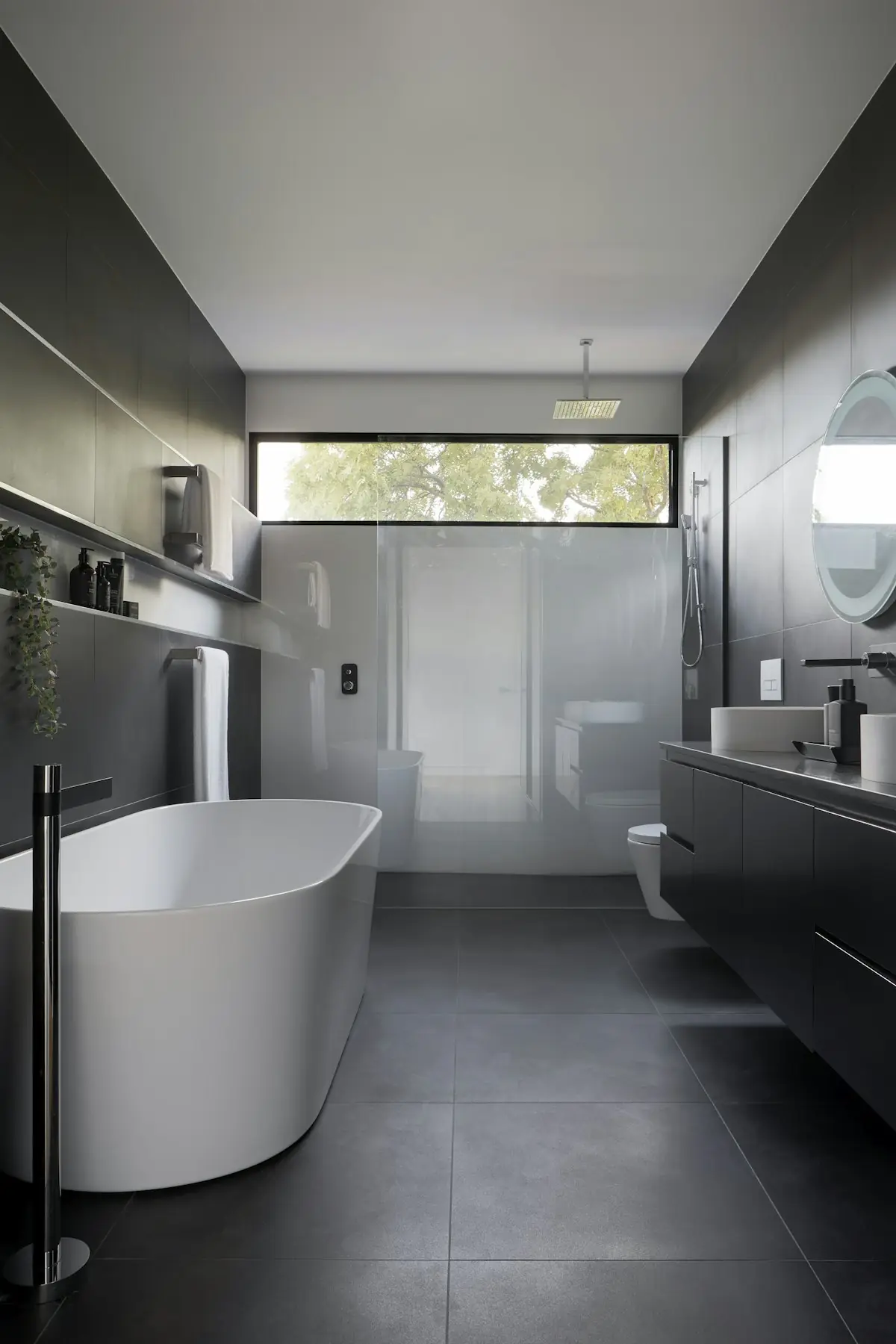 Dark grey bathroom with white freestanding bath